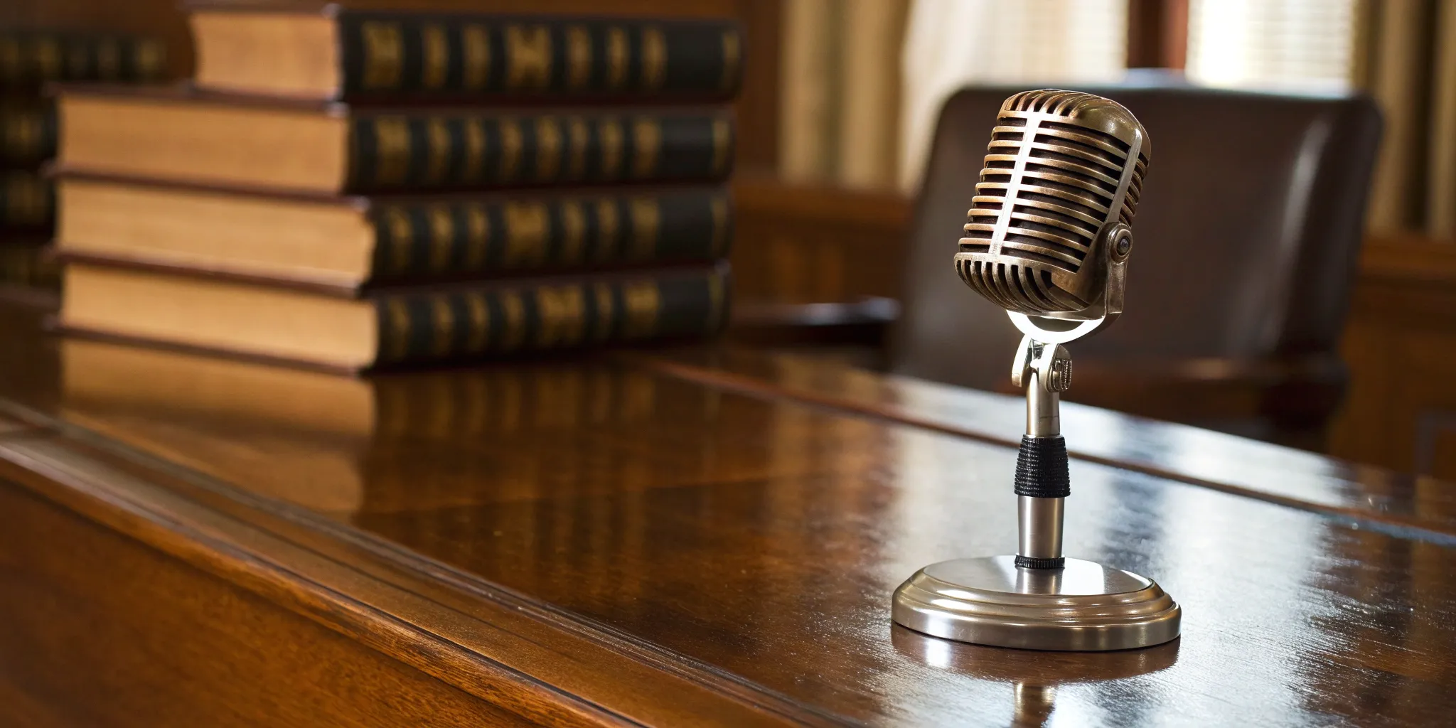 Vintage microphone on a desk for an expert preparing for a radio guest list interview.